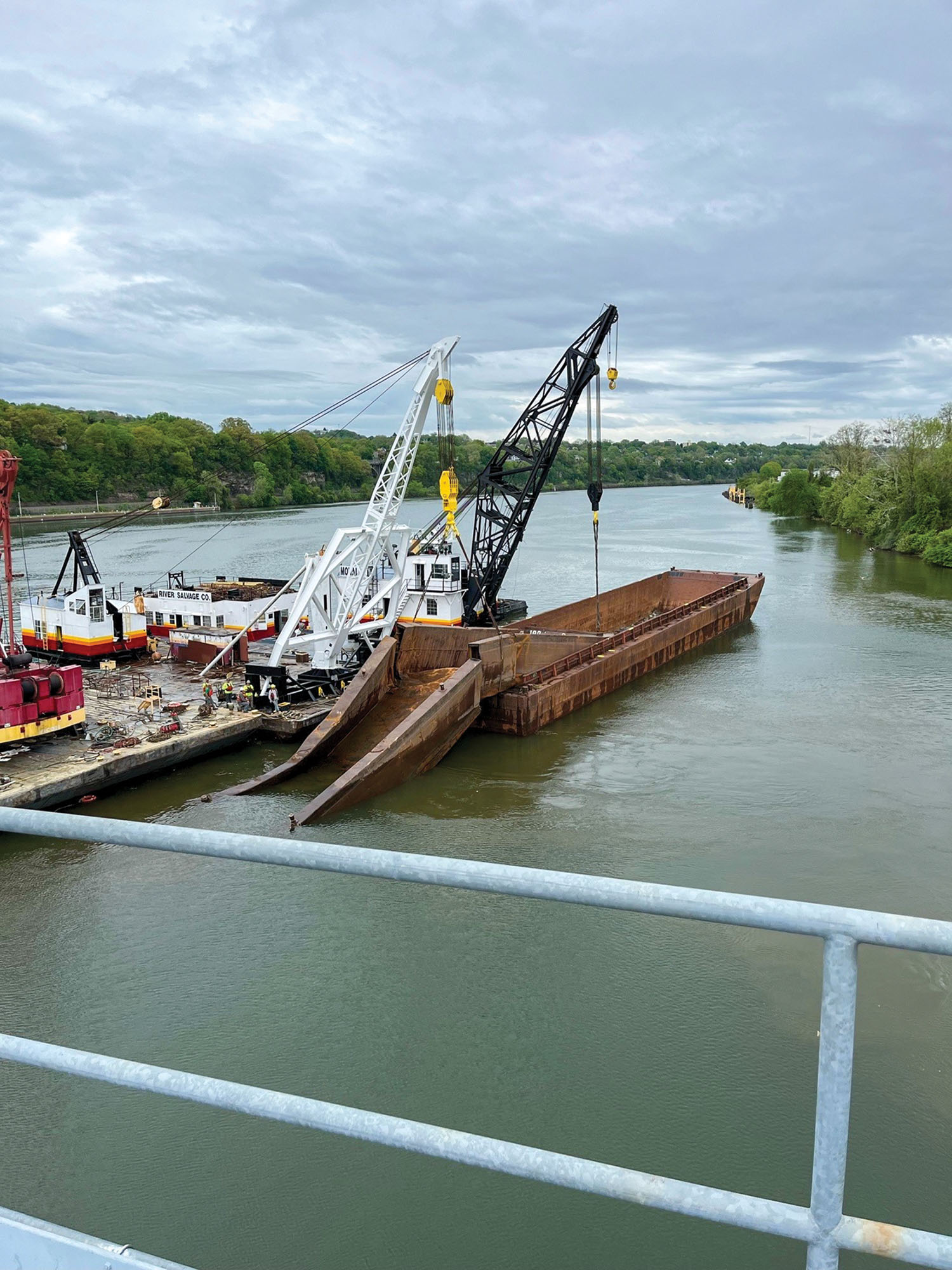 Crews removed two barges from where they were pinned against Emsworth Locks and Dam following a 26-barge breakaway in the Pittsburgh area on April 12. One barge remains lodged at Dashields Locks and Dam more than a month after the breakaway. (Photo courtesy of Pittsburgh Engineer District)