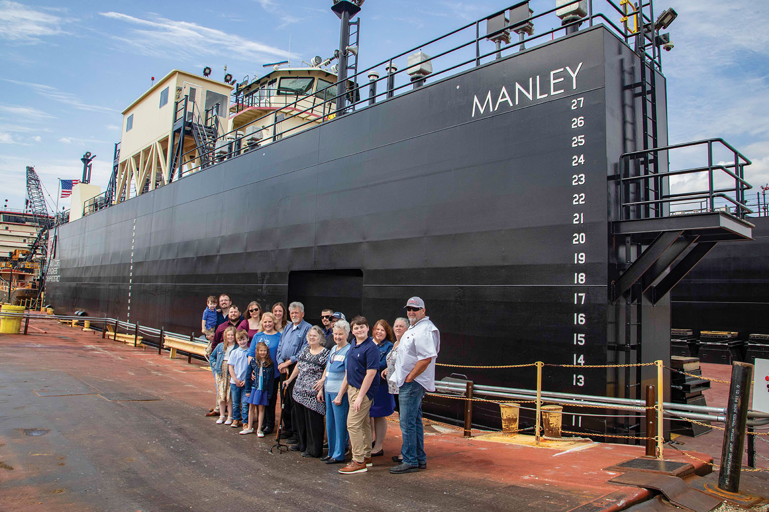 Family members of Billy Manley pose in front of the newly christened drydock Manley at the Ensley Engineer Yard. (Photo by Vance Harris/Memphis Engineer District)