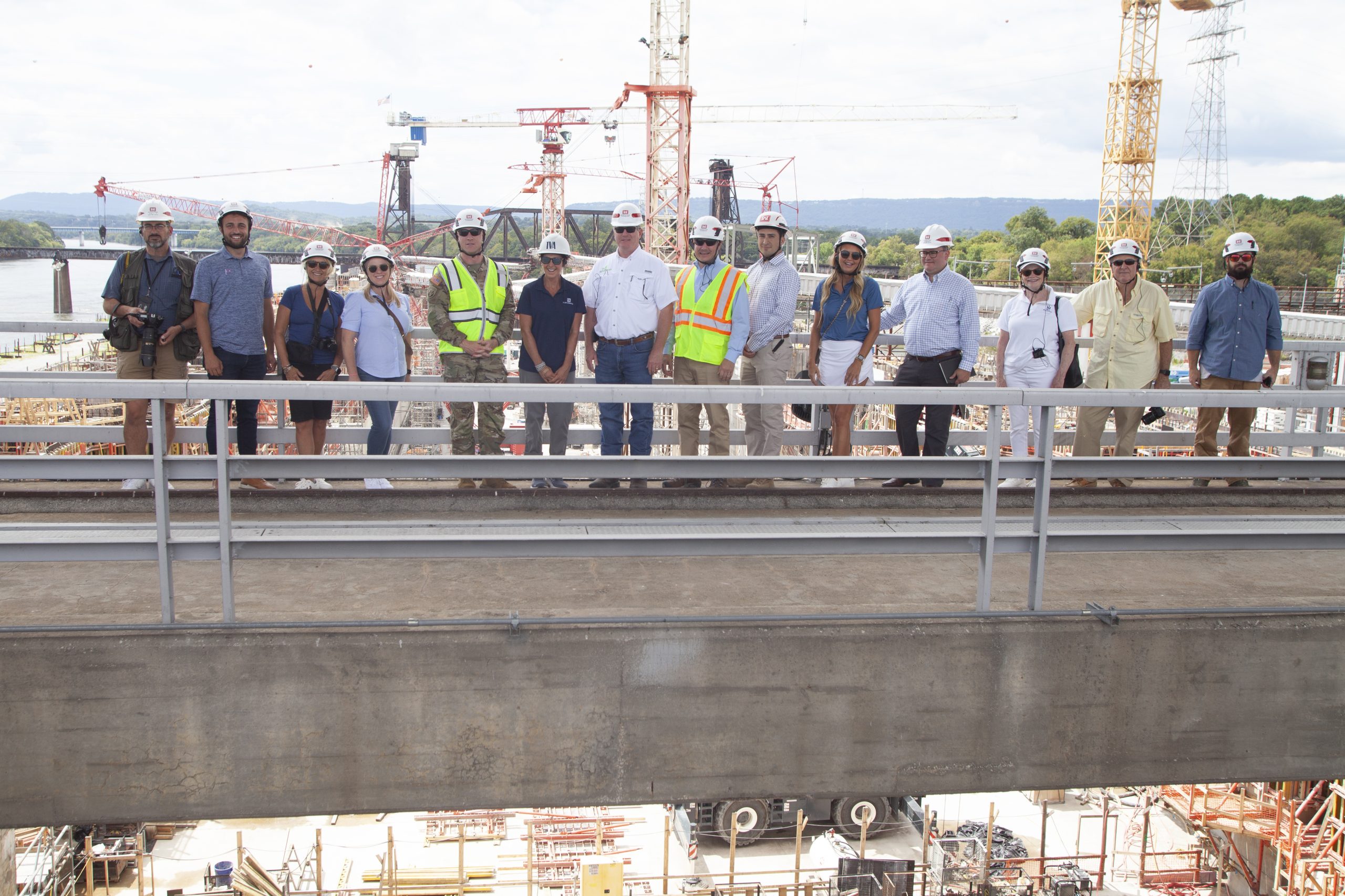 Representatives from Waterways Council Inc., the Nashville Engineer District, the barge and farming industries, and the media pose for a photo on Chickamauga Dam, overlooking the new lock construction site.