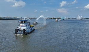 The mv. Jeff Kindl transports a crucifix through the New Orleans harbor as part of the August 14-15 Fête-Dieu du Mississippi, or blessing of the Mississippi River fleet. (Photo courtesy of ACBL)