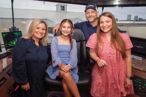 Capt. Ryan Battlefield stands in the wheelhouse of the mv. ACBL Mariner with his wife, Crystal, and his daughters, Lacey (right) and Lainey. (Photo by Frank McCormack)